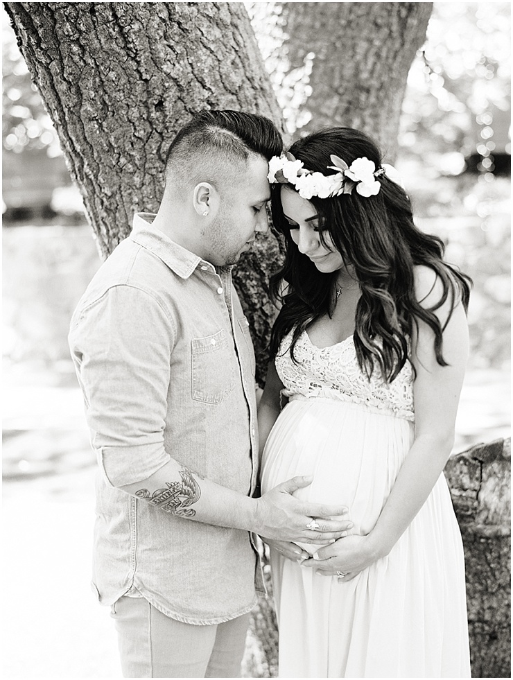 Black and white maternity session image of a mother to be wearing a floral crown.
