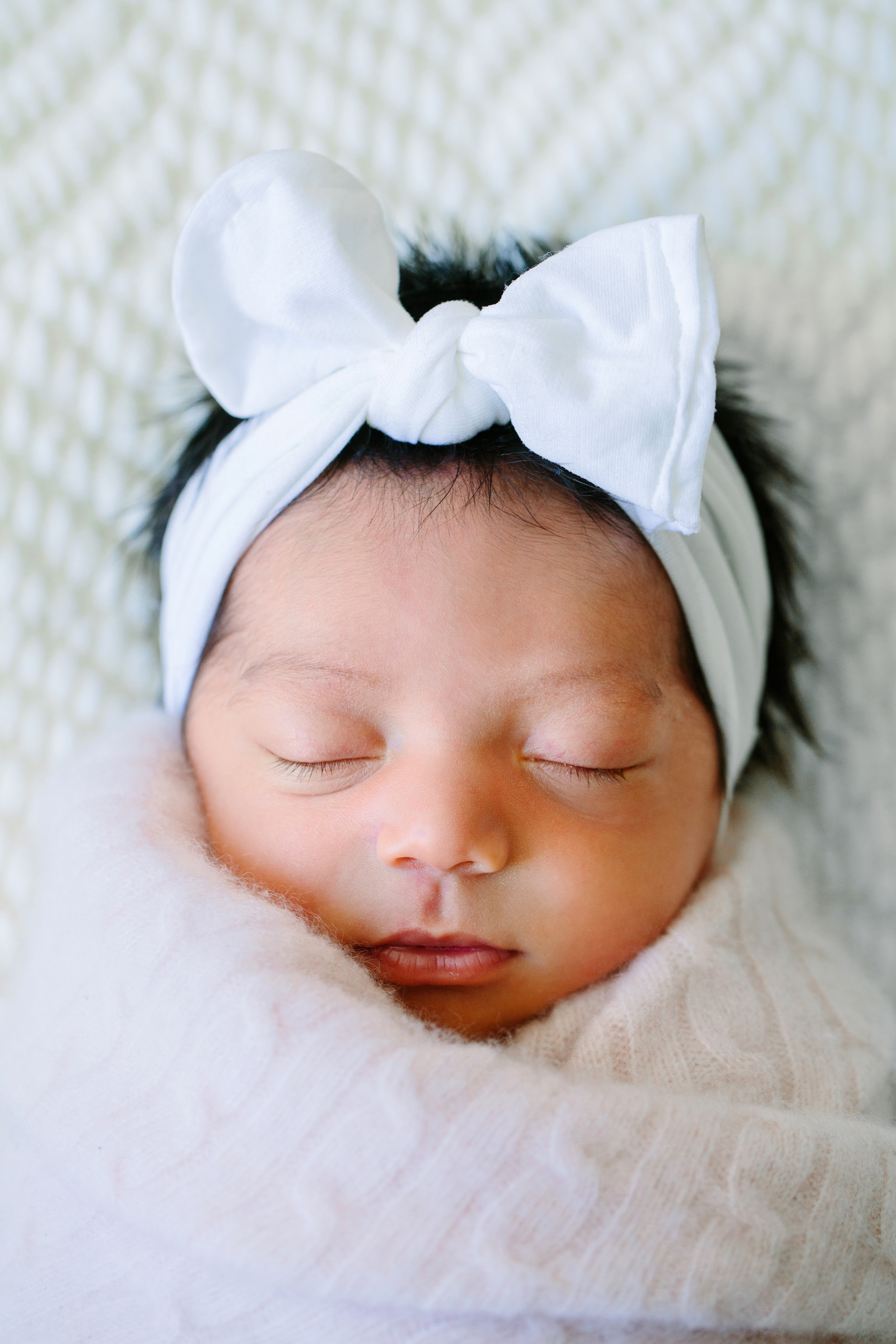 A newborn baby girl photographed in the natural light studio of Camarillo newborn photographer Daniele Rose