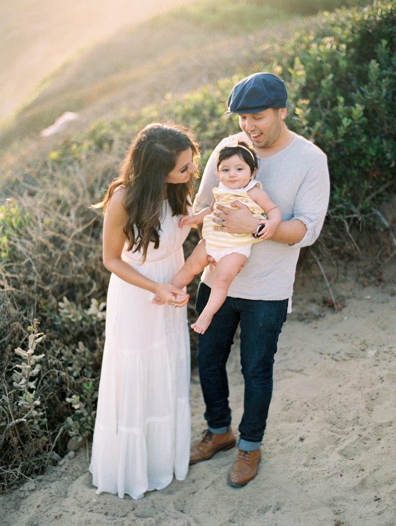 A family poses with their baby during their Malibu family photo session