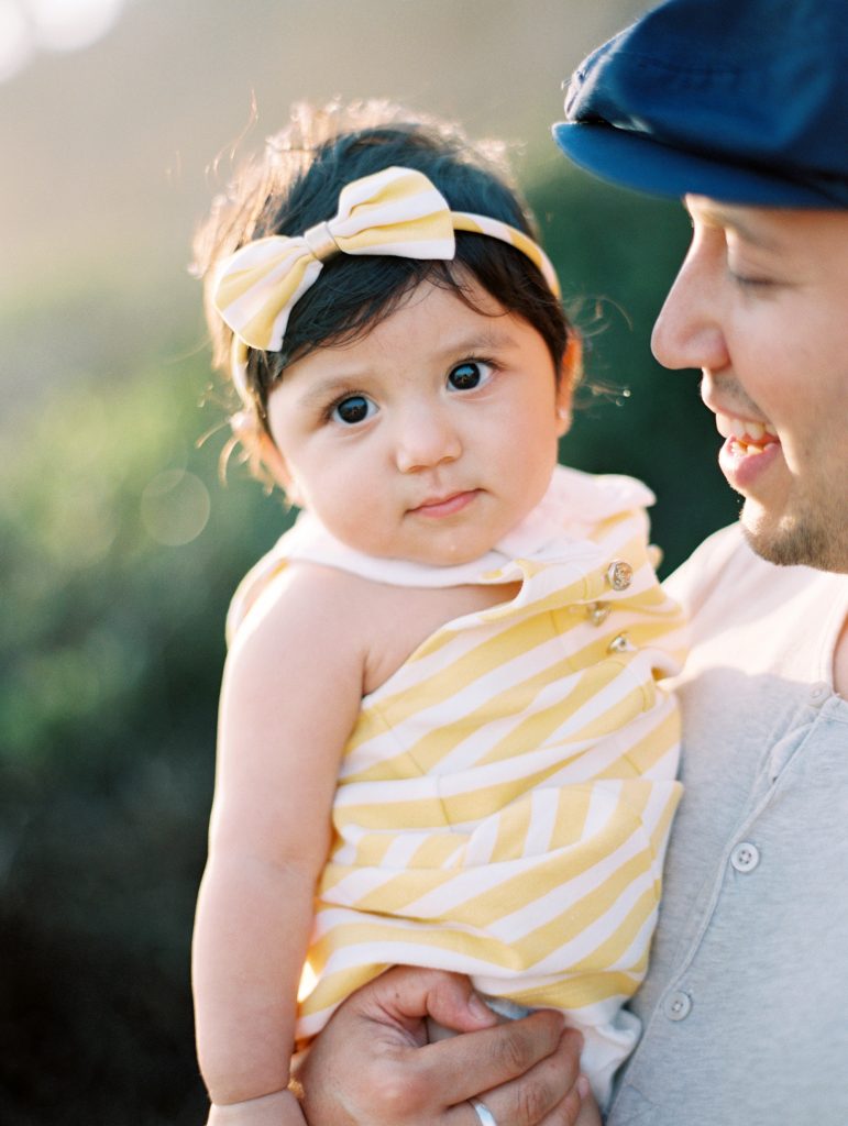 A baby and her dad snuggle during their Malibu family portrait session.