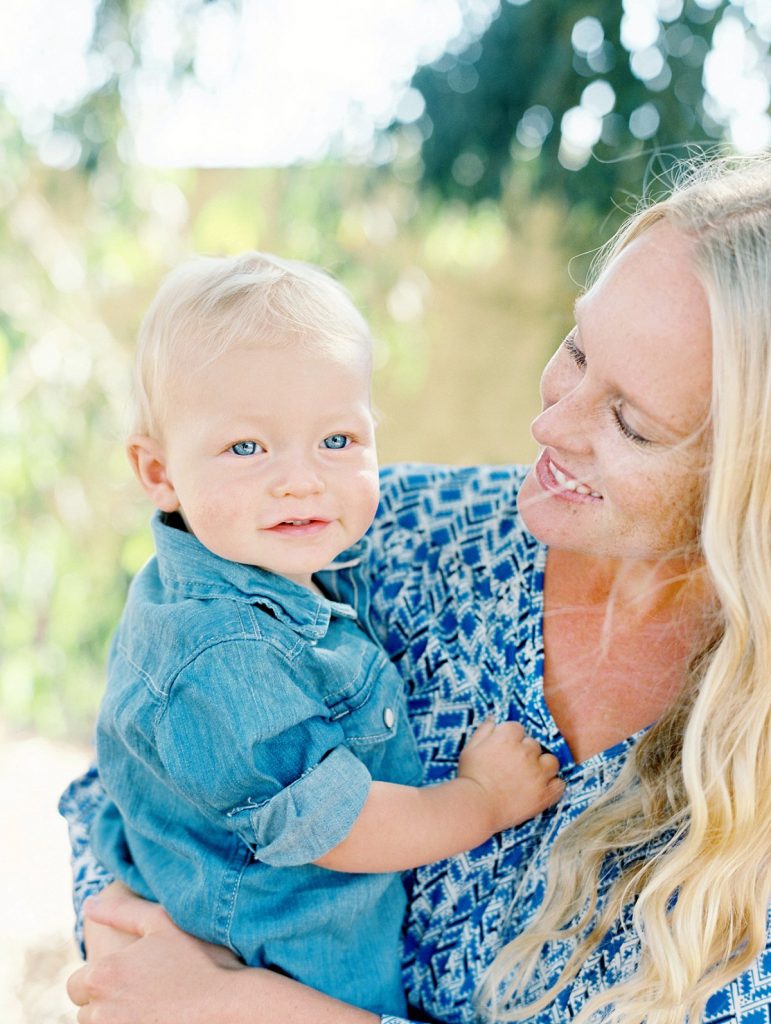 A mother looks at her blue eyed baby boy during their Camarillo family portrait session