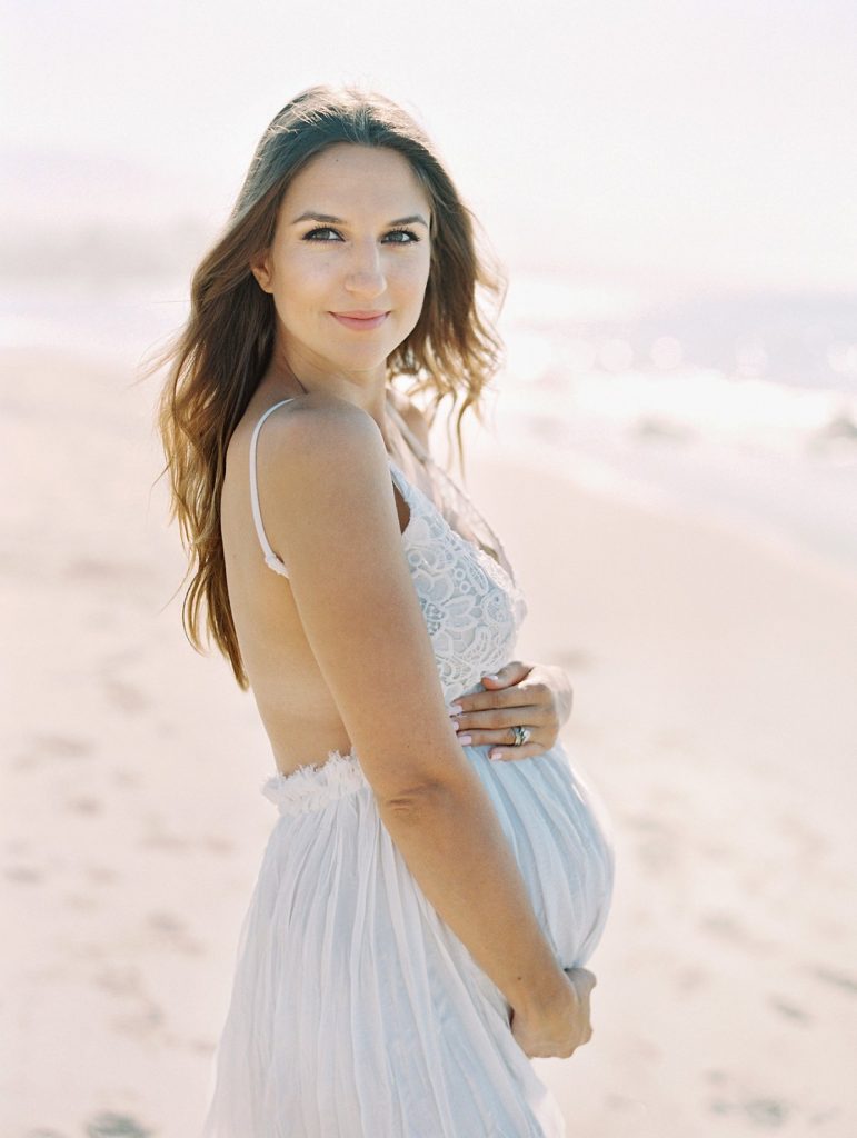 A Santa Barbara beach maternity portrait taken by photographer Daniele Rose