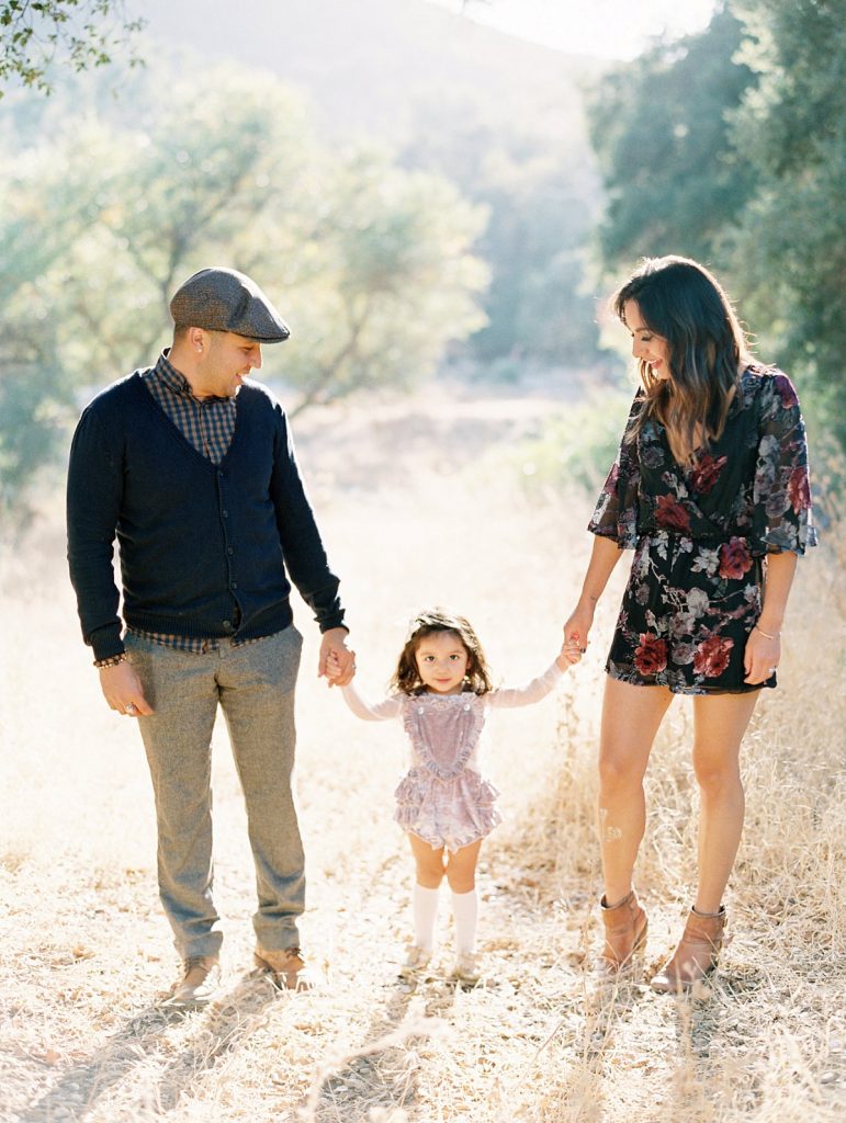 Parents smile at their daughter during their Thousand Oaks portrait session