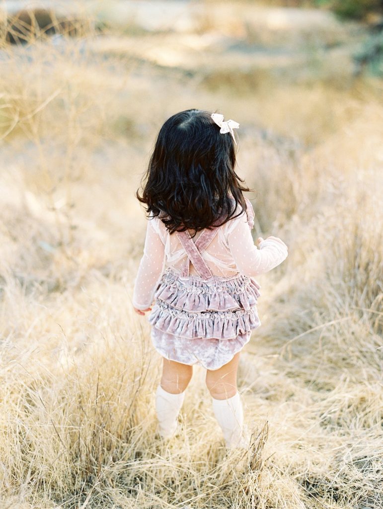Thousand Oaks Child Photographer Daniele Rose's portrait of a little girl standing in a field of golden grass