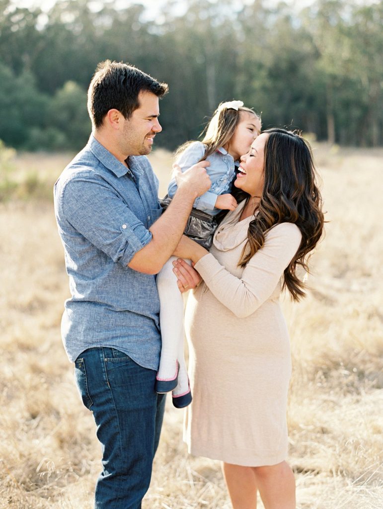 A family snuggles and plays in a photo by Thousand Oaks family photographer Daniele Rose