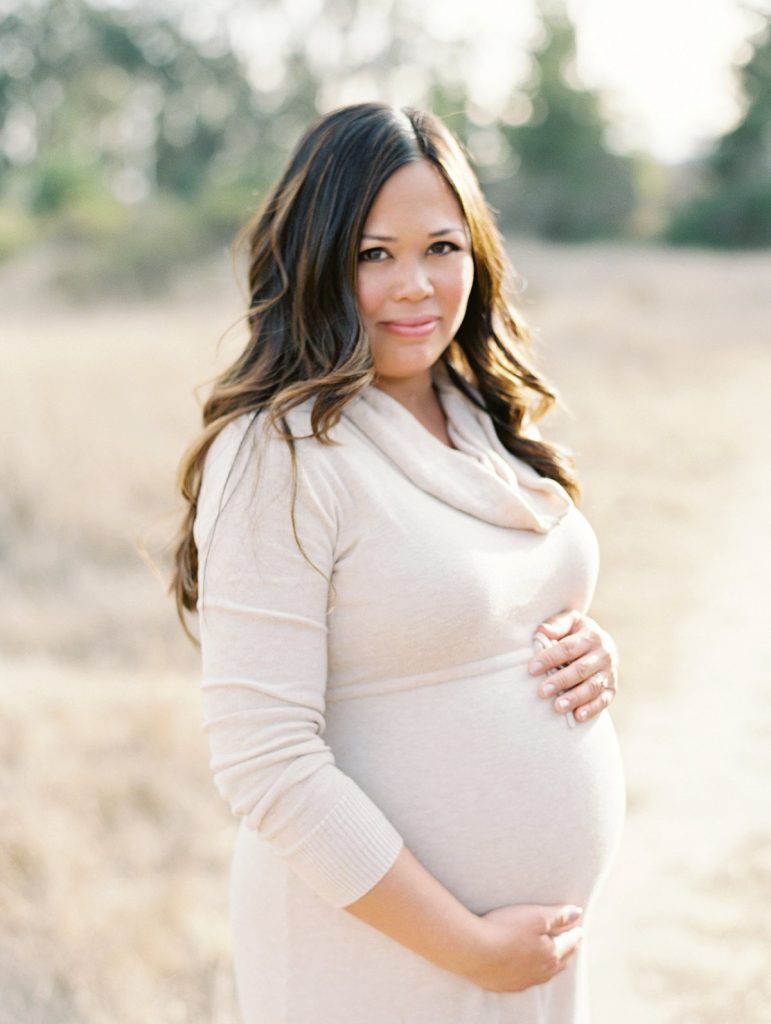 An expectant mother stands in a golden field in Thousand Oaks, California