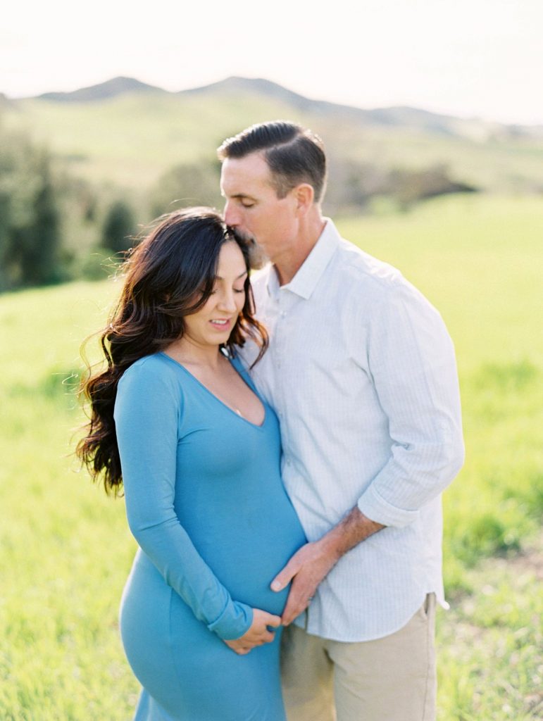 Thousand Oaks maternity photographer Daniele Rose captures a husband kissing his pregnant wife on the forehead