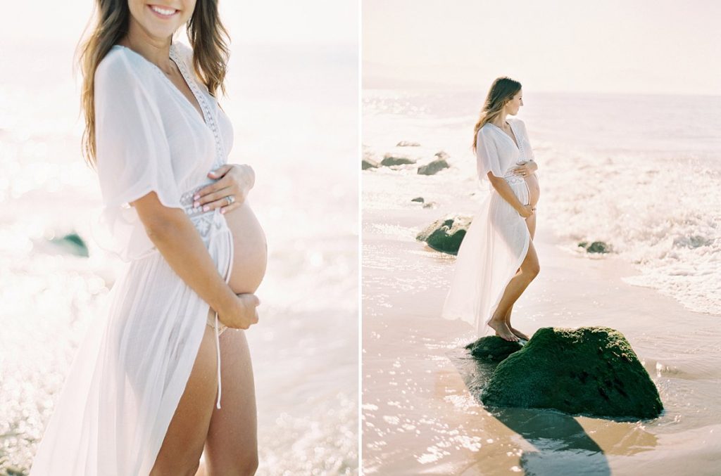 A pregnant mom to be in a white dress on the beach in Santa Barbara during her maternity portrait session with photographer Daniele Rose.