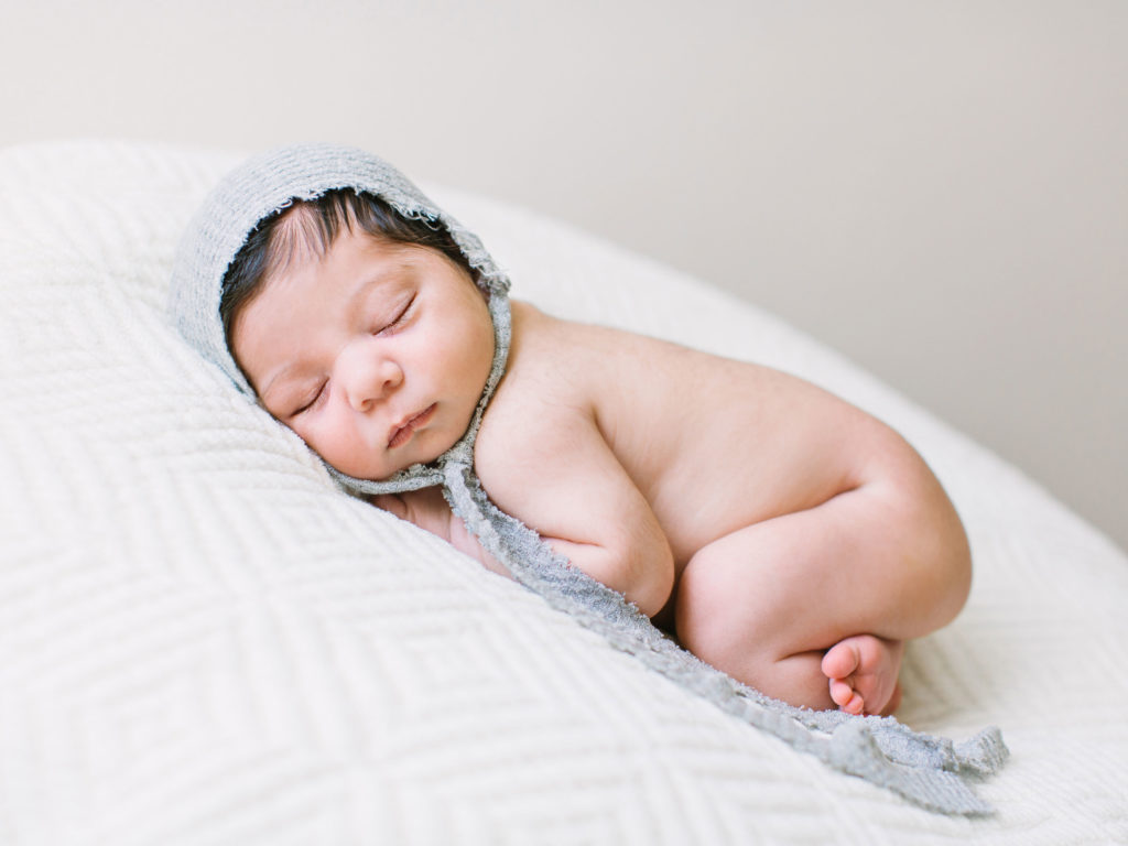 Newborn baby girl being photographed during her newborn photo session with Thousand Oaks newborn photographer, Daniele Rose in this post on how to prepare for newborn photos.