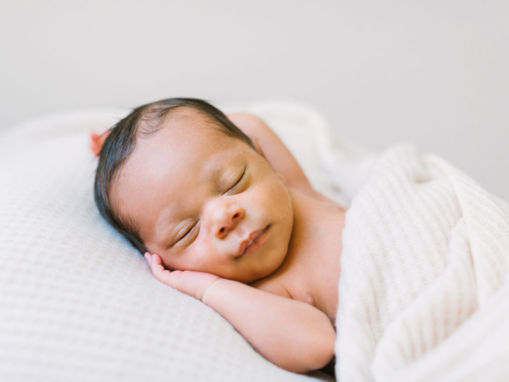 A baby boy sleeping during his newborn photo session with Thousand Oaks newborn photographer, Daniele Rose.