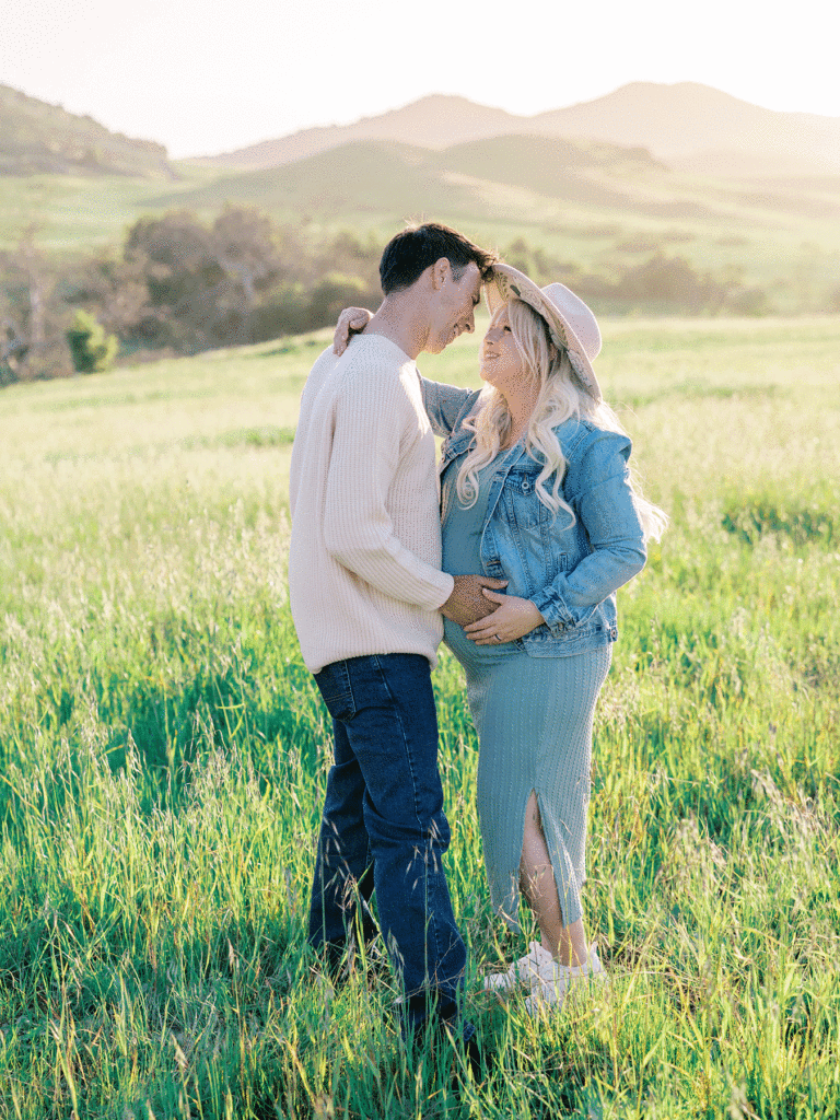 Couple in a green field during a spring family portrait session by Ventura County photographer Daniele Rose