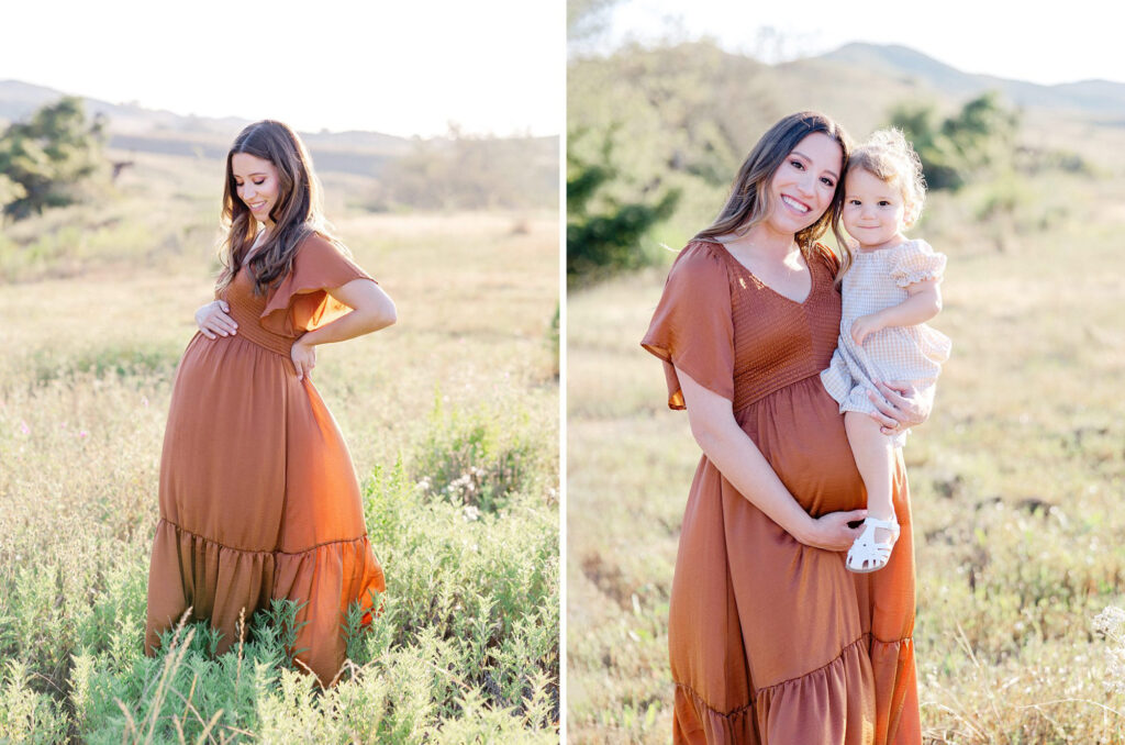 A pregnant mom in a fall colored orange dress holds her belly and her toddler during their fall family photo session.