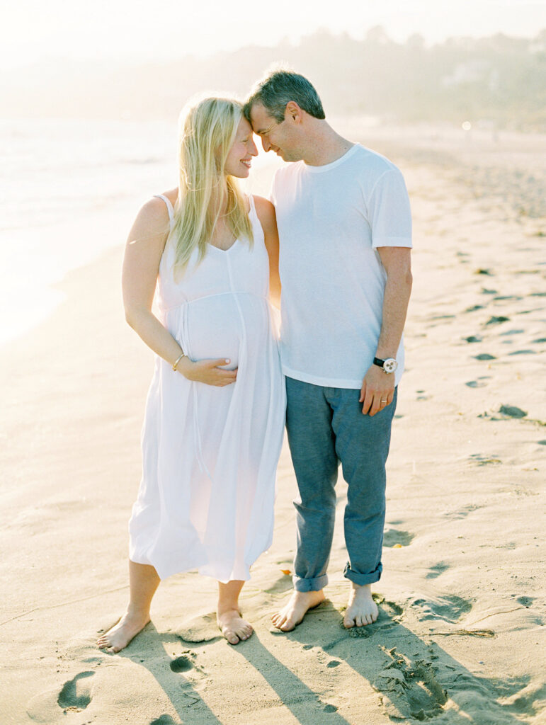 A couple on Zuma Beach during their Los Angeles Maternity session with photographer Daniele Rose