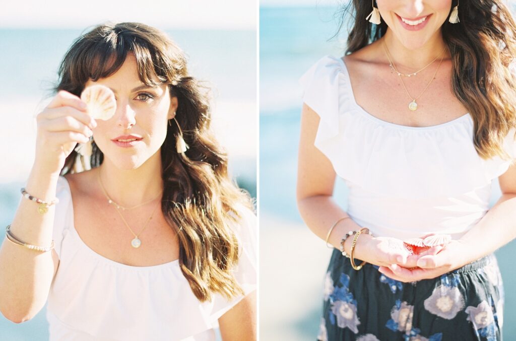 Woman holding seashell on Malibu beach showcasing natural, candid moments during family photography session